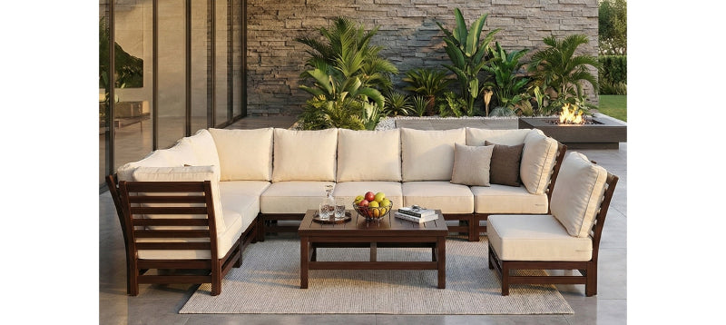 Outdoor patio furniture set with beige cushions and a wooden coffee table.